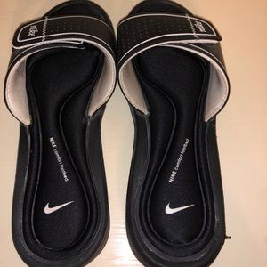 Woman’s Nike slides.